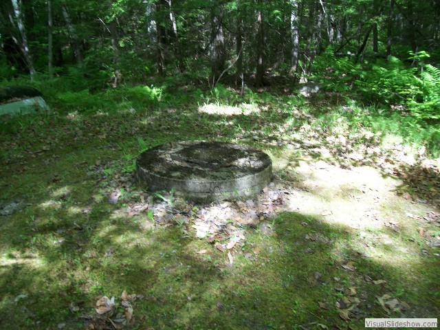 Dug well at woodland spring  w/filtered sunlight in the forest glen 