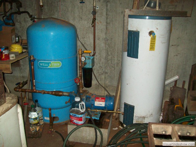 dug well at woodland spring with pump in basement